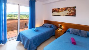 A hotel room with two beds, a balcony, and a painting on the wall. - Nice apartment with terrace and pool near the beach and shops Inmosantos Daniel AticA (Rosas / Roses)