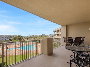 A balcony with a pool view, outdoor furniture, and a clear sky. - Gulf and Pool Views, Free Seasonal Beach Service, Designated Beach Area on 30A!! (Santa Rosa Beach)