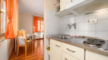 Fridge, coffee/tea maker, cookware/dishes/utensils