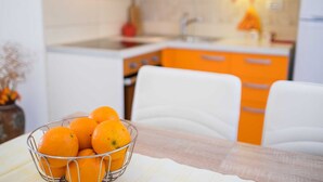 A kitchen with orange cabinets and a sink. - Apartment IVA with a sea view (Krk)