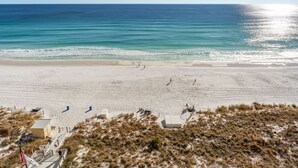 A beach with a sandy shore, a few people, and a clear sky. - Gulf Front Balcony, Gorgeous Views, Near Destin Harbor (Destin)