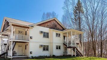 A two-story house with a porch, a staircase, and a small front yard.