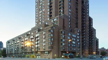 A high-rise building with multiple floors, large windows, and a flat facade.