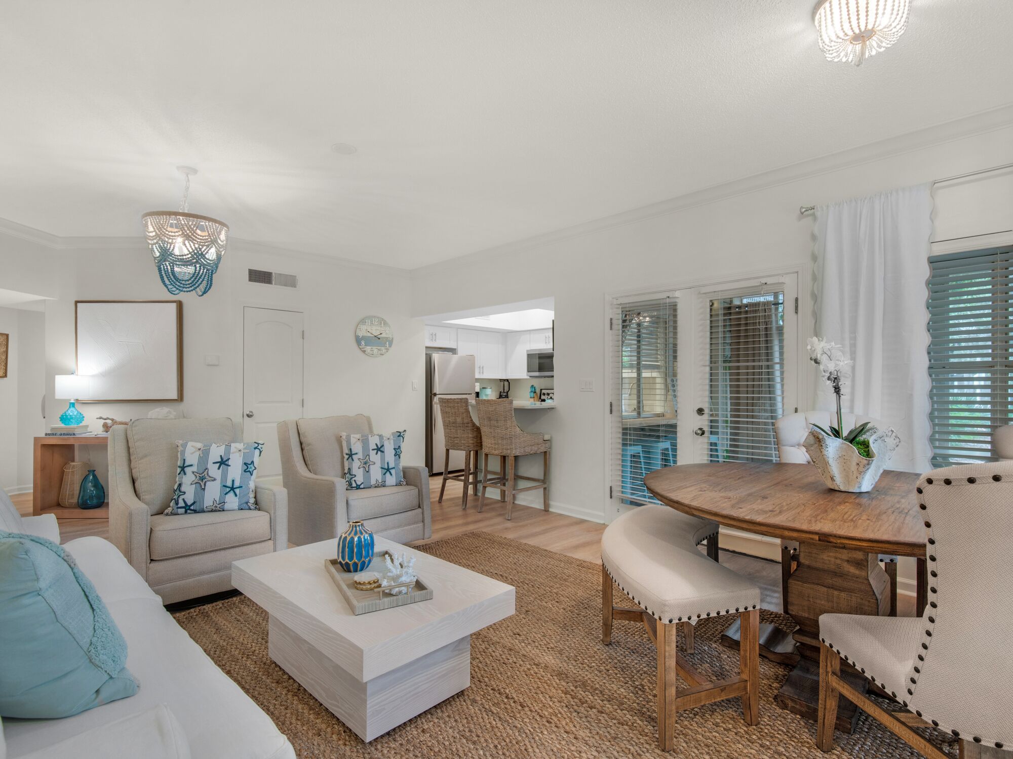 A spacious living room with a sofa, coffee table, and dining area.