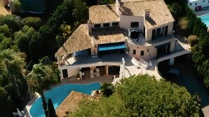 A large, multi-story house with a swimming pool, surrounded by lush greenery. - Large sea-view villa with 3 independent apartments (Mandelieu-la-Napoule)