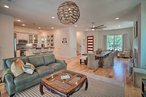 A modern living room with a sofa, coffee table, and dining area. - Walk to Lake Austin: Spacious Getaway w/ Patio (Austin)