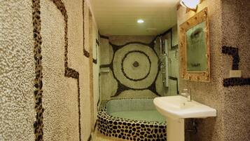A bathroom with a leopard print bathtub, a white sink, and a mirror on the wall.