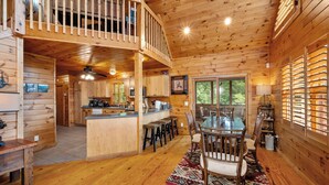 A spacious cabin with a large dining area, a kitchen, and a cozy living space. - Brook Haven: Private Cabin, Great Views, Hot Tub, WiFi, Fireplace (Ferguson)