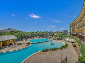 Relax by the resort's large, curved pool surrounded by lounge areas and a covered patio.