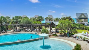 Ein Resort mit großem Pool, Liegebereichen und Blick auf den Ozean.