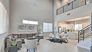 A spacious living area with a sofa, chairs, a dining table, and artwork on the walls. - 7 Mi to Dtwn Phoenix: Group-Friendly Getaway (Phoenix)