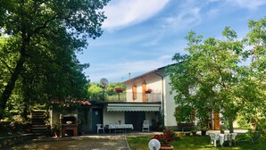 A house with a balcony, a garden, and a gravel driveway. - The House Of Antonella Casentino, Arezzo, Tuscany, Italy  (Subbiano)