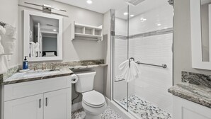 A modern bathroom with a glass-enclosed shower, a marble countertop, and a toilet. - Newly Renovated Garden View 2 bed, 2 bath at Sanibel Moorings #641 (Sanibel)