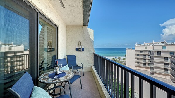 A balcony with a table, chairs, and a view of the ocean. - Beach Views right on Siesta Key/Crescent Beach. Amazing location! (Sarasota)