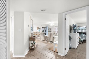 A spacious living room with a dining area, a kitchen, and a child's bedroom. - Ground Floor, Walk to the Beach, Pool,  Beach Chair Service Included (Miramar Beach)