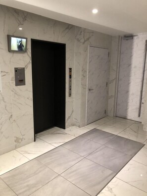 Elevator area with a digital display and control panel.
