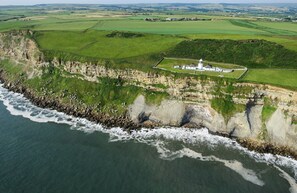 Aerial view - Galatea a three bedroom lighthouse keepers cottage with sea views. (Whitby)