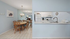A modern kitchen with white cabinets, a built-in microwave, and a stainless steel sink. - Tropical Garden View 2 bed, 2 bath at Sanibel Moorings #622 (Sanibel)