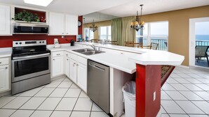 A modern kitchen with white cabinets, stainless steel appliances, and a large island. - IBR 7008: Memories by the Sea - Where Dreams Meet the Ocean! (Fort Walton Beach)