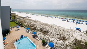 A resort with a swimming pool, beach umbrellas, and a beach view. - IBR 7008: Memories by the Sea - Where Dreams Meet the Ocean! (Fort Walton Beach)