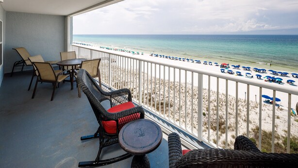 A balcony with wicker furniture and a view of the beach. - IBR 7008: Memories by the Sea - Where Dreams Meet the Ocean! (Fort Walton Beach)