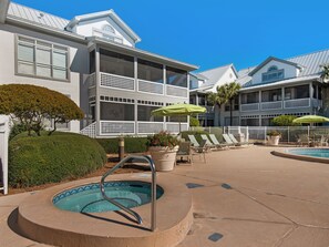 A hotel with a swimming pool, lounge chairs, and a well-maintained garden. - Wrap-Around Balcony, Two Swimming Pools, Walk to the Beach (Miramar Beach)
