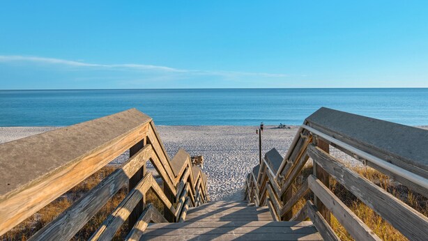 A wooden boardwalk leading to a beach with a clear blue sky. - At the Beach - Gulf Views - Pool (Miramar Beach)