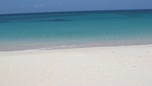 A beach with clear turquoise water and white sand. - Compound w/Beach, Pool,  Pickleball, Gym, Kayaks, Golf Carts, Views! (Governors Harbour)