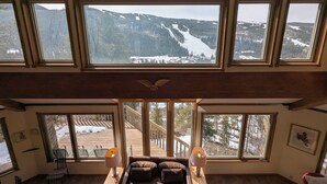 A high-ceiling room with large windows offering a view of a snowy mountain landscape. - Pet friendly (with fees) Great views (Keystone)