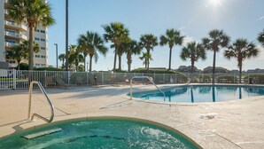 A swimming pool area with lounge chairs and palm trees. - Hear the Waves, Big Balcony, Look at the Beach, Unique, Spacious (Miramar Beach)