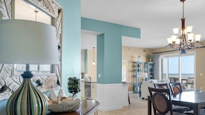 A dining area with a chandelier, a large vase, and a view of the ocean. - Hear the Waves, Big Balcony, Look at the Beach, Unique, Spacious (Miramar Beach)