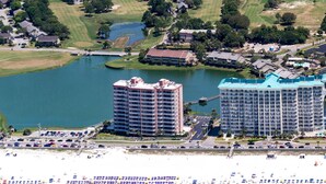 An aerial view of a coastal area with a large hotel, a beach, and a lake. - Hear the Waves, Big Balcony, Look at the Beach, Unique, Spacious (Miramar Beach)
