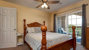 A bedroom with a bed, a ceiling fan, a sliding glass door to a balcony, and a white door. - 24-6 Serenity Escape Penthouse w/Indoor/Outdoor Pool / Splash Pad Near SDC (Branson)