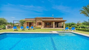 A pool with blue water, surrounded by blue lounge chairs. - FRANCISCA  Ref. VP03 (Alcúdia)