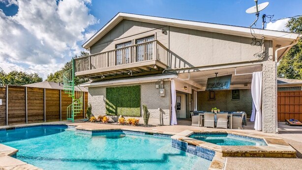 A two-story house with a backyard pool, a covered patio, and a satellite dish. - Ultimate Texas Experience With Heated Pool & Spa (Dallas)