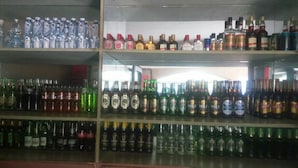 A liquor store with shelves stocked with various bottles of alcohol. - Kabz Hotel (Kampala)