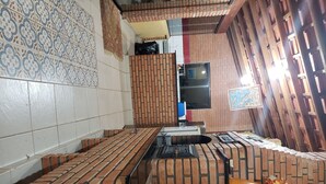 A kitchen with a brick backsplash, a built-in stove, and a tiled backsplash. - Beautiful house with the best View (Sao Roque)