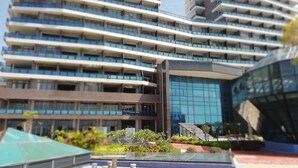 A modern multi-story building with balconies and a glass facade. - Seacliff Apartment (Shantou)