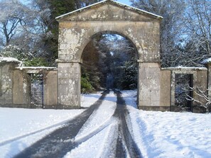 A snow-covered road leading through an arched stone bridge. - Cloverhill Gate Lodge Relax Refresh and Unwind promises tranquillity (Co Cavan)