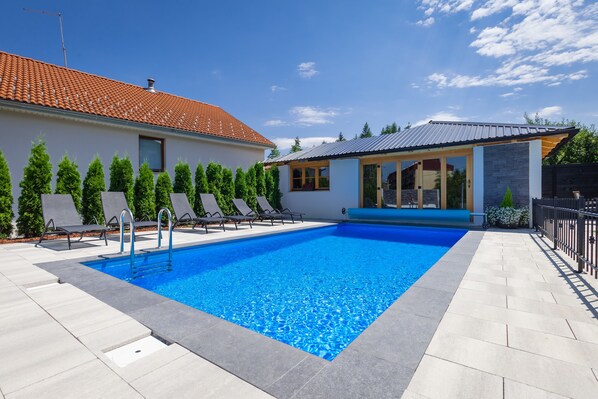 Seasonal outdoor pool, pool umbrellas, pool loungers