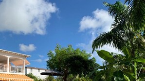 A backyard with a pool, lounge chairs, and a covered patio area. - F3 FROM 2 TO 6 BEDS 10 MN BEACH BOURG DE SAINTE ANNE (SAINTE ANNE)
