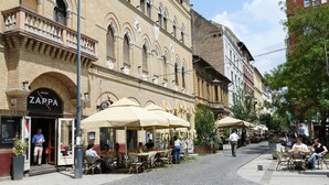 A street with outdoor seating at a cafe named ZARPA.