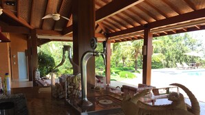 A covered outdoor area with a pool, lounge chairs, and a large decorative shell. - BEAUTIFUL PROPERTY IN PORTO FELIZ (Porto feliz)