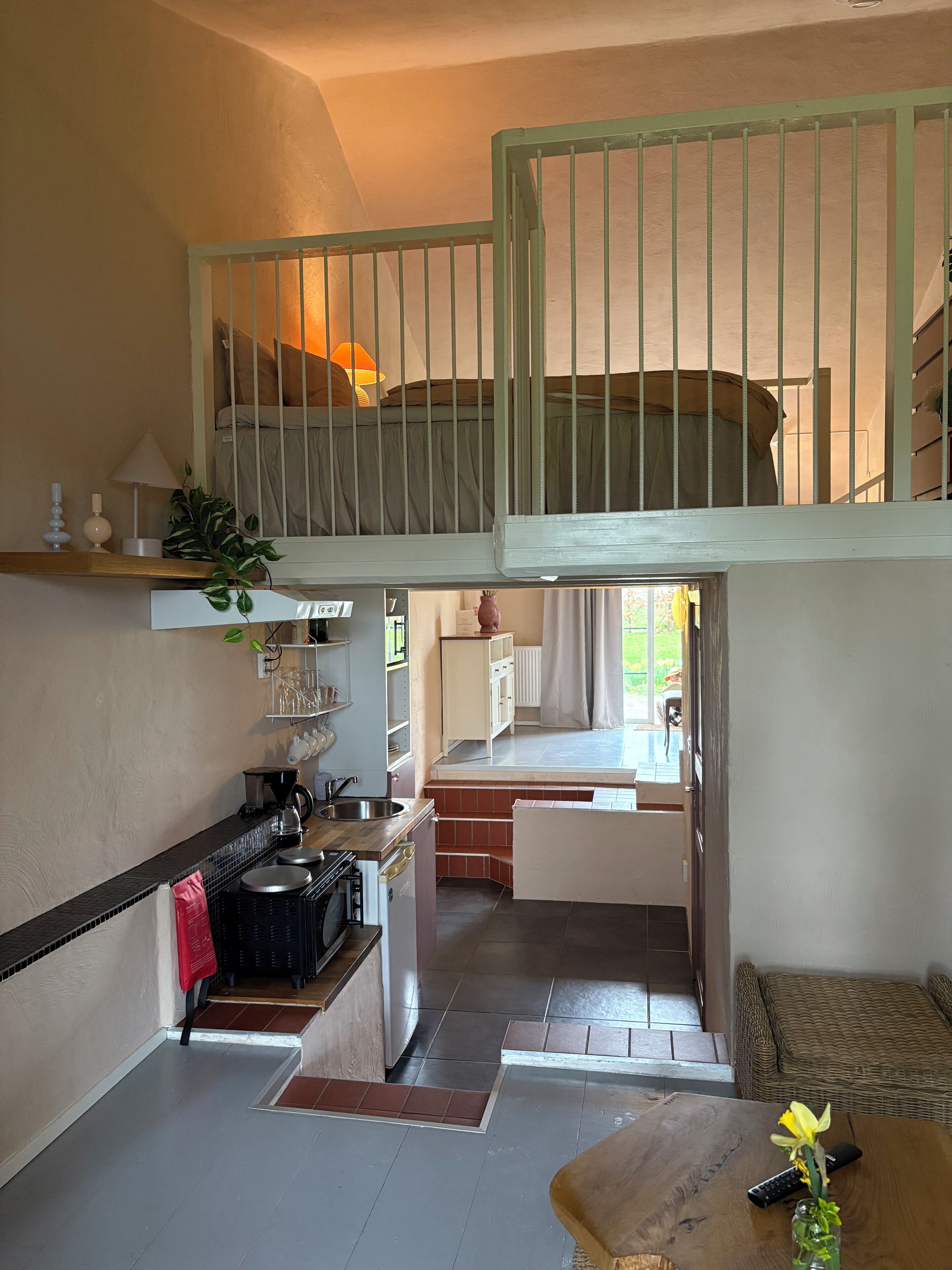 A compact living space with a kitchenette, a dining area, and a small seating area.