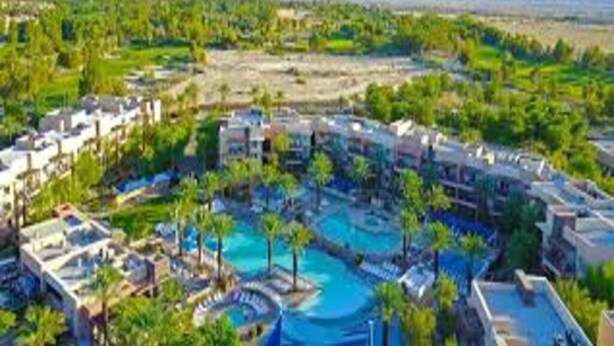 A resort with multiple swimming pools, lush greenery, and a mountainous backdrop. - Marriott Resort Palm Desert (Palm Desert)
