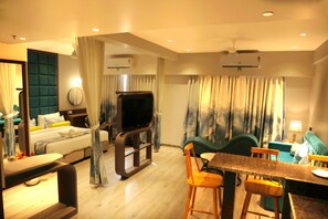Superior Suite | Living area | 43-inch Smart TV with satellite channels - Hotel The Excellency (Surat)