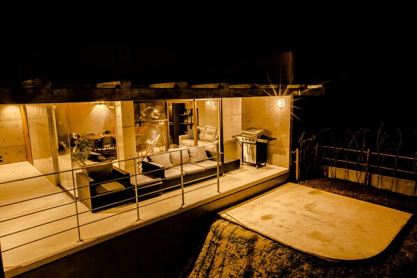 A modern, well-lit interior with a seating area, a kitchen, and a dining space. - The:MOVES-Musée Villa- (Nakijin)
