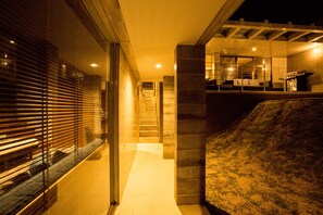 A modern interior with a staircase leading to a kitchen area, featuring a gas stove and a dining setup. - The:MOVES-Musée Villa- (Nakijin)