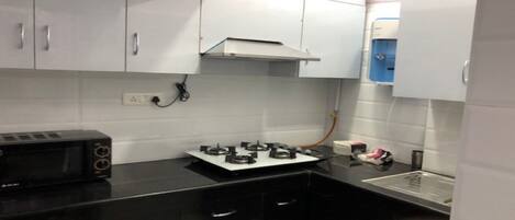 Fridge, microwave, coffee/tea maker, cookware/dishes/utensils