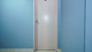 A closed door with a number plate, blue walls, and a tiled floor. - Hotel O Hotel Orchard Inn (Lumut)